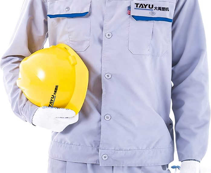 Service technician in TAYU work clothes holding a safety helmet